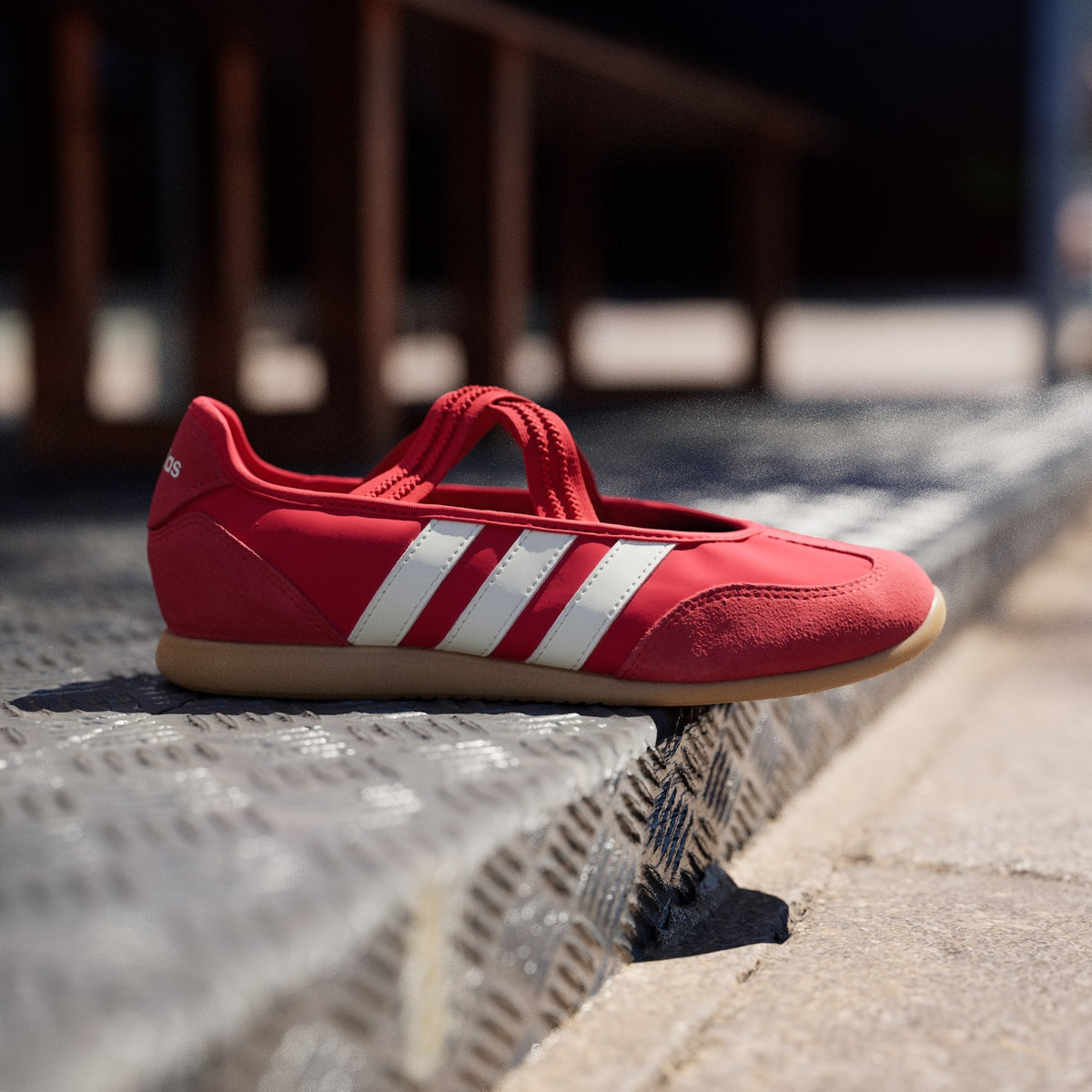 Red Adidas sneaker with white stripes