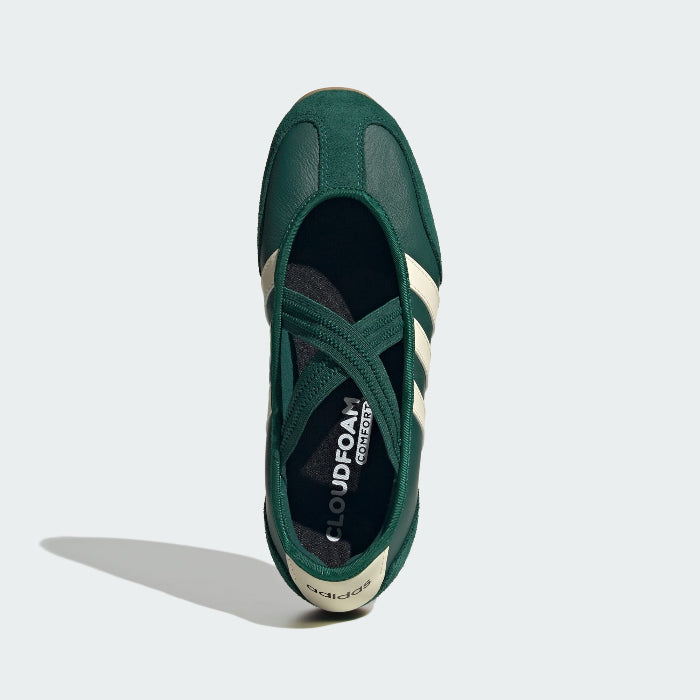 Green Adidas sneaker with white stripes on a light gray background