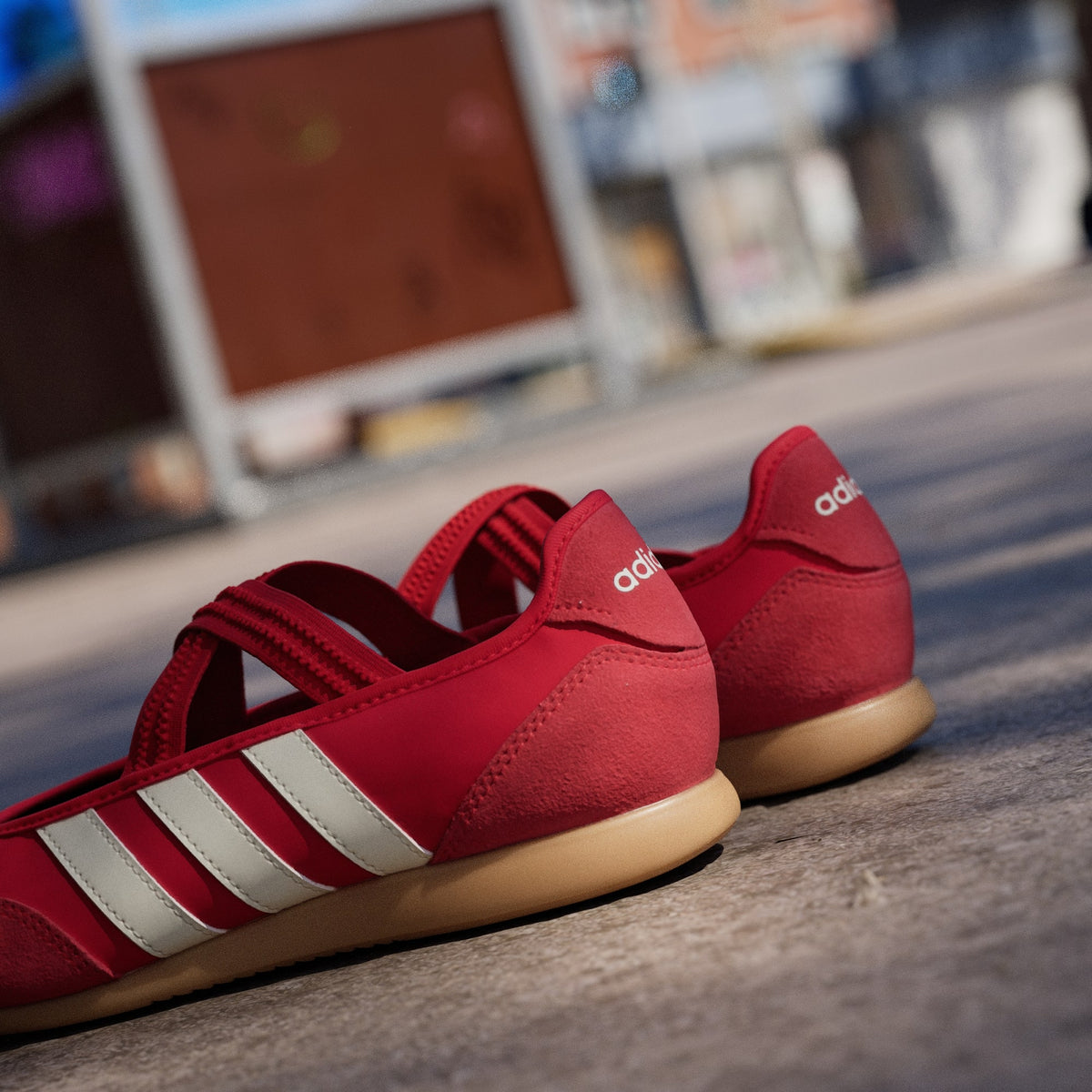 Red Adidas sneaker with white stripes