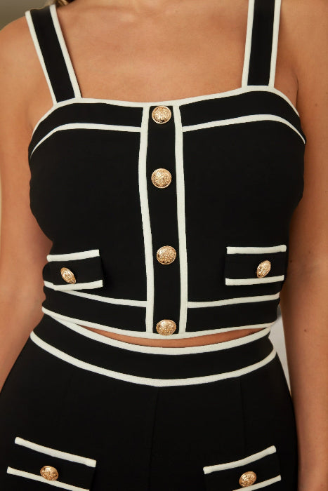 Black and white striped top with gold buttons on a person