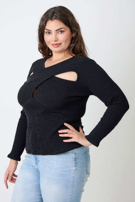 Woman wearing a black sweater with cut-out design and light blue jeans on a white background