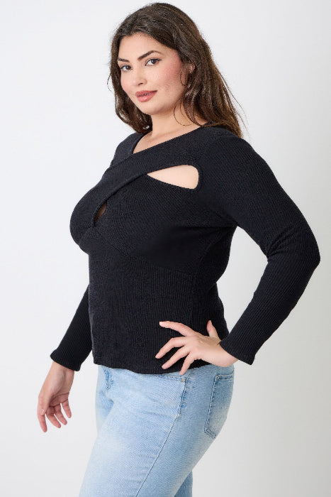 Woman wearing a black cut-out sweater with light blue jeans on a white background