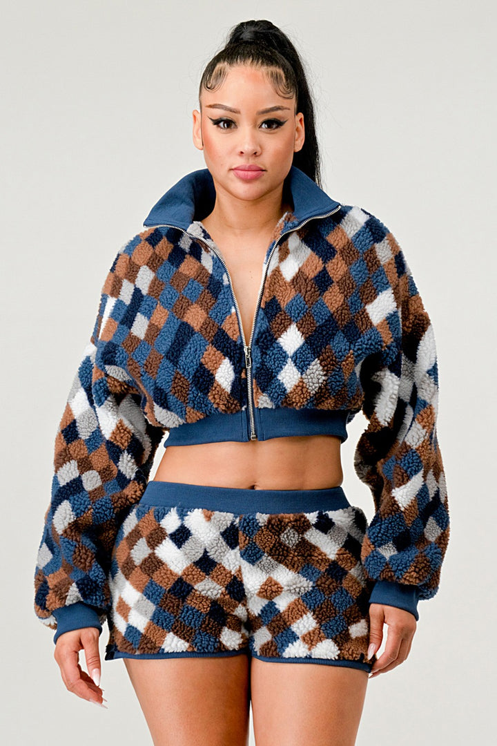 Woman wearing a patterned outfit on a plain background