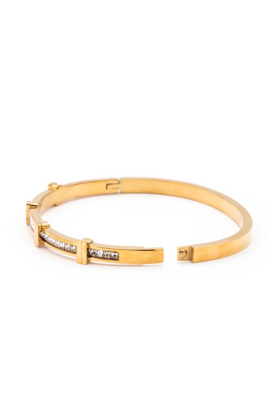 Gold bracelet with diamond accents on a white background