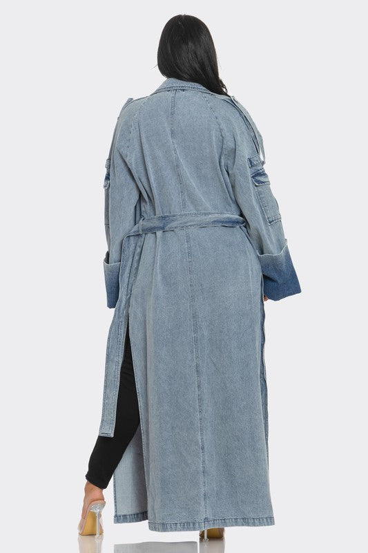 Denim trench coat worn by a person on a white background