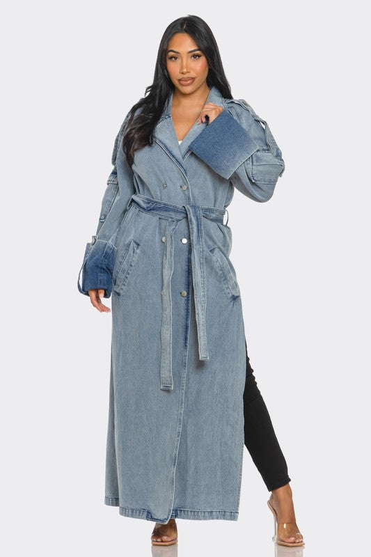 Woman wearing a long denim coat on a white background