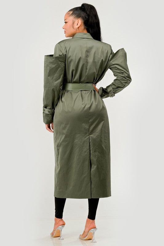 Woman wearing a green trench coat on a white background