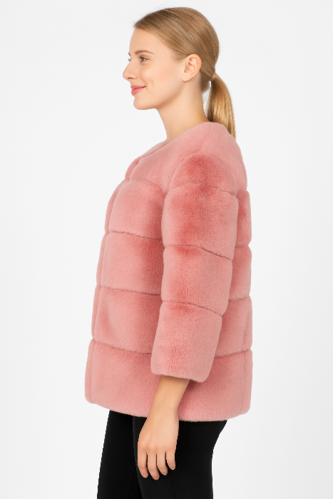 Woman wearing a pink fur coat on a white background
