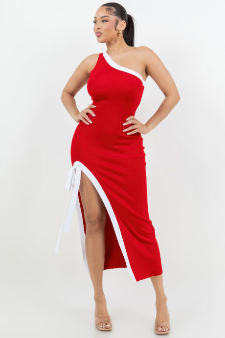 Woman wearing a red and white dress with a slit on a white background