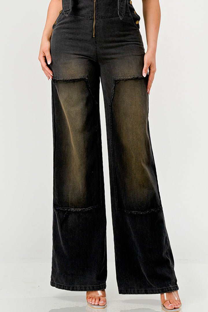 Black wide-leg overalls worn by a person on a white background