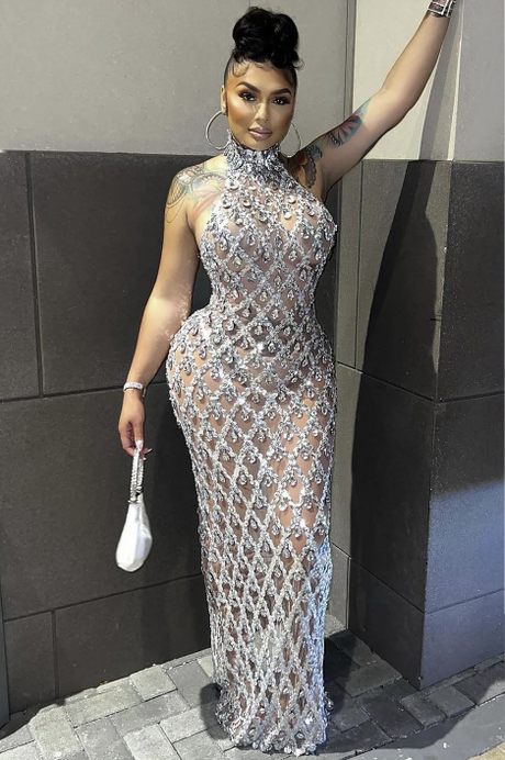 Model wearing the Midnight Rhinestone Dress Set standing against a wall and holding a white handbag