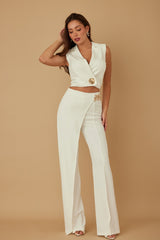 Woman wearing a white outfit with a beige background