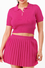 close up of woman wearing a bright pink polo shirt and pleated skirt on a white background