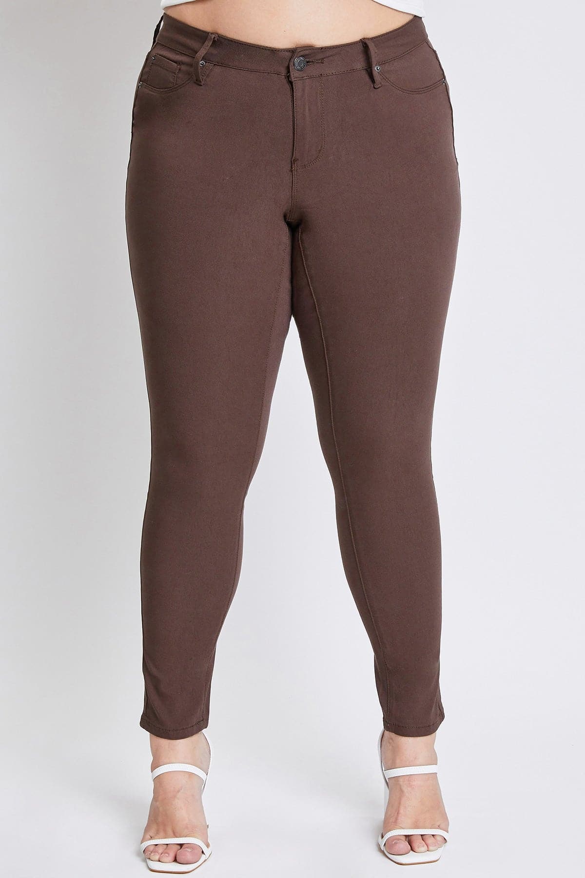 Brown pants worn by a person on a white background