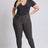 Woman wearing a black bodysuit and gray pants on a white background