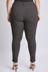 Dark gray pants worn by a person on a white background