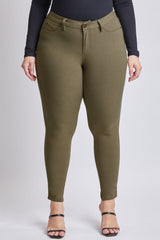 Olive green pants worn by a person on a white background