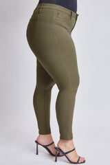 Olive green pants worn by a person on a light gray background