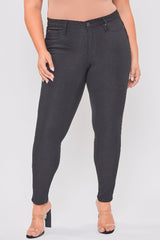 Black jeans worn by a person on a plain background