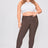 Woman wearing brown pants and a white top on a white background
