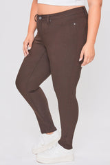Brown pants worn by a person on a light gray background