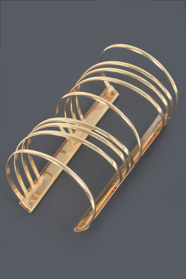 Gold metal bracelet with a Unique spiral design. Bold statement piece