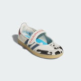 White Adidas Pixar Toy Story Samba Jane Shoes with cow print sole on a light gray background