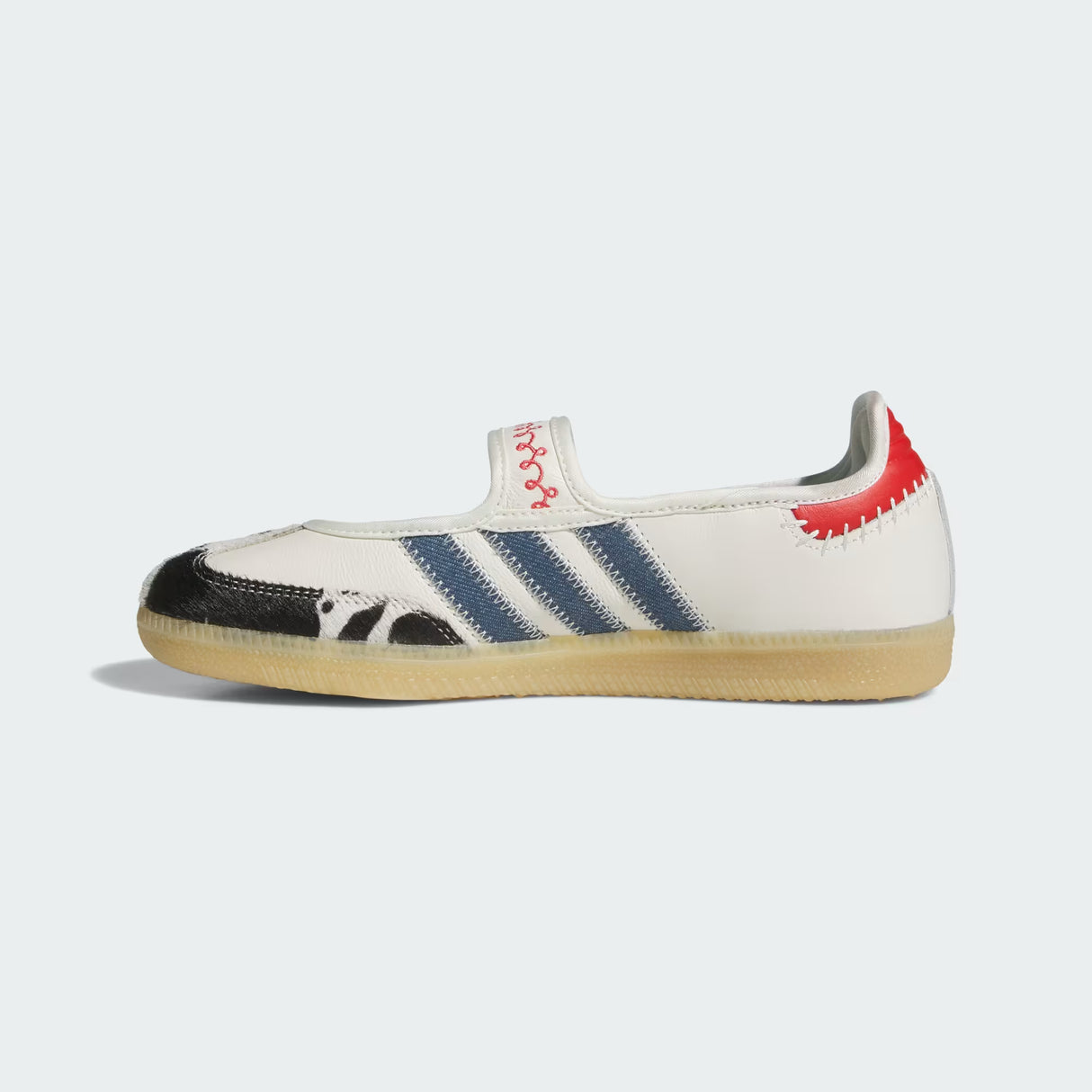 White Adidas Pixar Toy Story Samba Jane Shoe with blue stripes and red accents on a light gray background