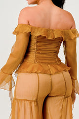 Mustard yellow off-shoulder top with ruffled details on a plain background