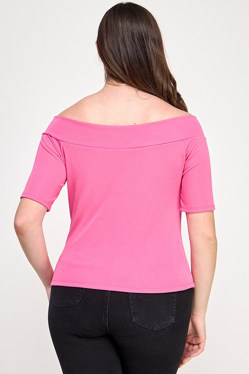 Woman wearing a pink off-shoulder top on a white background