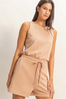 Woman wearing a beige Drawstring Waist Sleeveless Romper on a plain background
