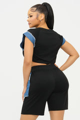 back view Woman wearing a black outfit with blue accents on a white background