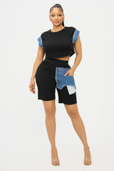 Woman wearing a black and denim short set on a white background