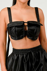 Black satin top with unique design on a plain background