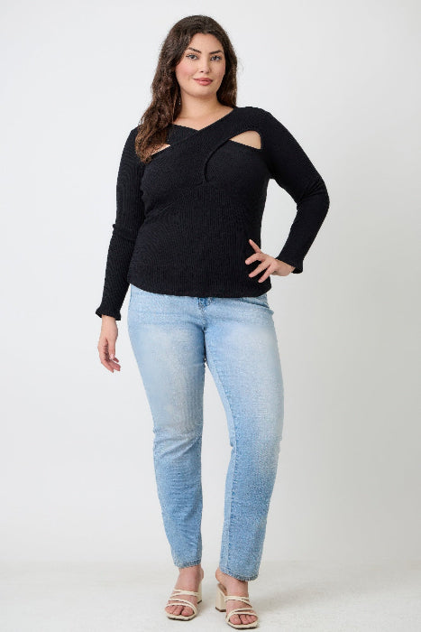 Woman wearing a black long-sleeve top and light blue jeans on a white background