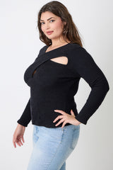 Woman wearing a black cut-out sweater with light blue jeans on a white background