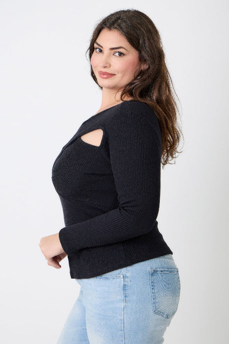 Woman wearing a black sweater with cut-out design on a white background