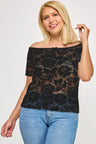 Woman wearing a black lace top and blue jeans on a white background