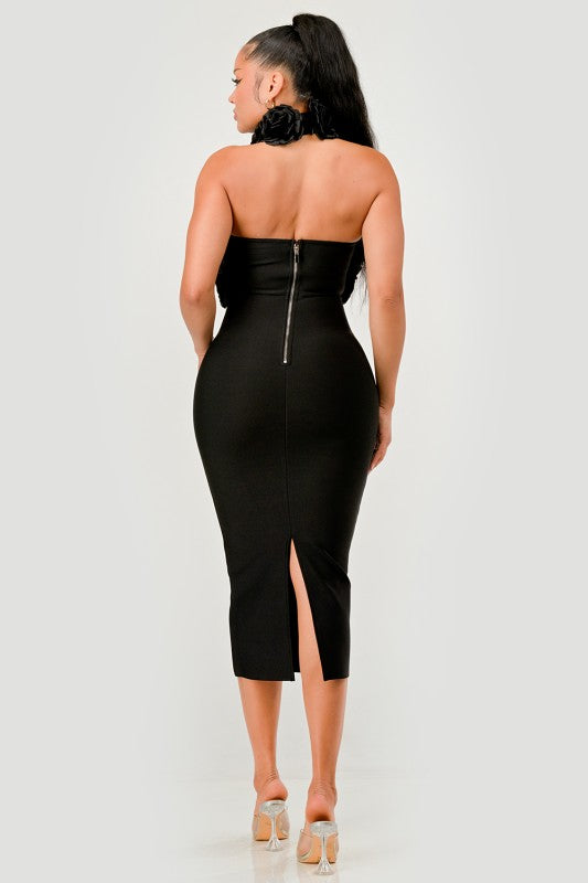 Black strapless dress with a zipper back and slit on a white background