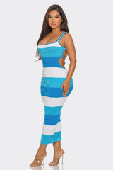side view of Woman wearing a blue and white striped dress on a white background