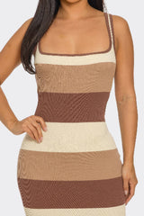 close up of Woman wearing a brown and beige striped dress against a white background