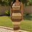 Woman wearing a brown and beige striped dress outdoors.