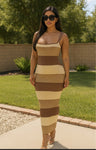 Woman wearing a brown and beige striped dress outdoors.