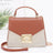 Brown handbag with gold accents on a white background