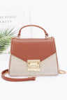 Brown handbag with gold accents on a white background