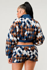 Woman wearing a patterned outfit with a checkered design on a plain background