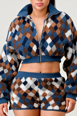 Woman wearing a patterned outfit with a matching jacket and shorts.
