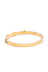 Gold bracelet on a white background