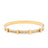 Gold bracelet with embedded stones on a white background