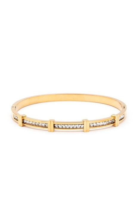 Gold bracelet with embedded stones on a white background